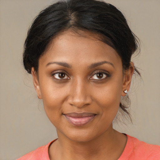 Joyful black young-adult female with medium  brown hair and brown eyes