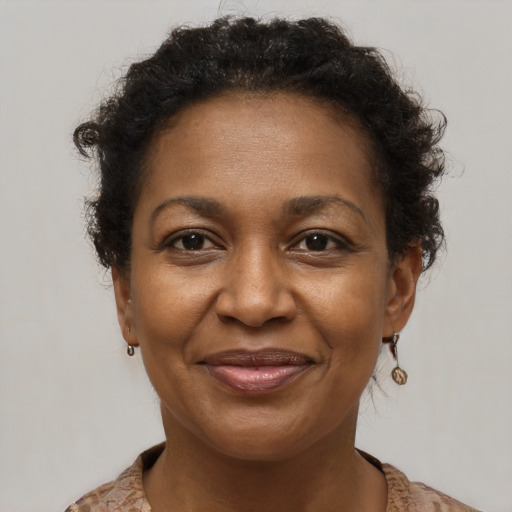 Joyful black adult female with short  brown hair and brown eyes