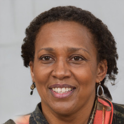 Joyful black adult female with medium  brown hair and brown eyes