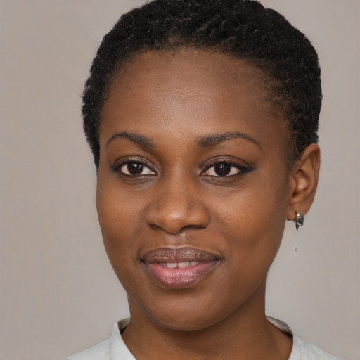 Joyful black young-adult female with short  brown hair and brown eyes