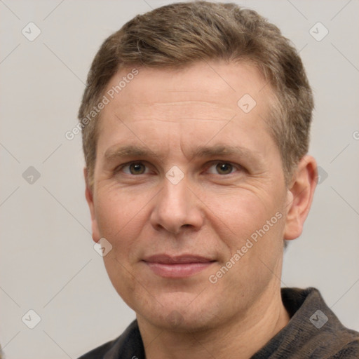 Joyful white adult male with short  brown hair and grey eyes