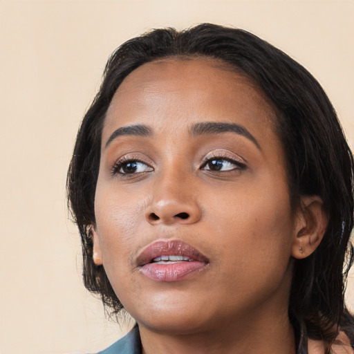 Joyful latino young-adult female with medium  black hair and brown eyes