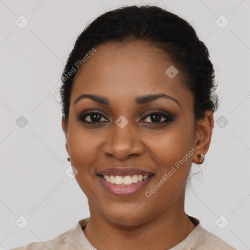 Joyful black young-adult female with short  black hair and brown eyes