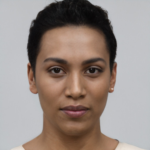 Joyful latino young-adult female with short  black hair and brown eyes