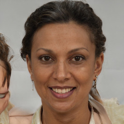 Joyful black adult female with medium  brown hair and brown eyes