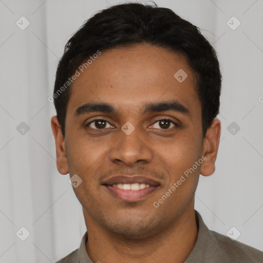 Joyful black young-adult male with short  brown hair and brown eyes