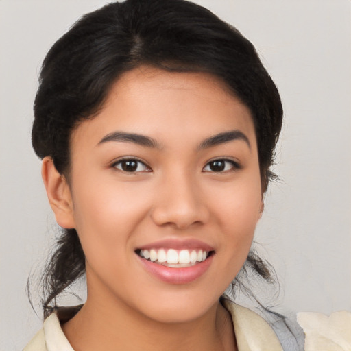 Joyful latino young-adult female with medium  black hair and brown eyes