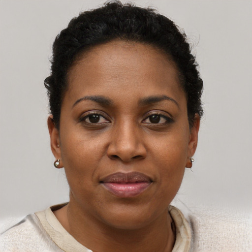 Joyful black young-adult female with short  brown hair and brown eyes