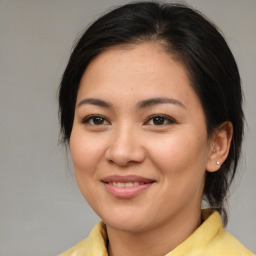 Joyful asian young-adult female with medium  brown hair and brown eyes