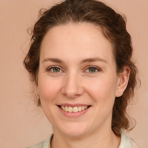 Joyful white young-adult female with medium  brown hair and green eyes