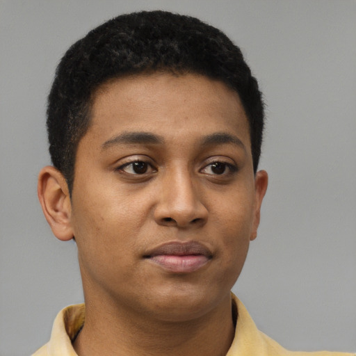 Joyful black young-adult male with short  brown hair and brown eyes