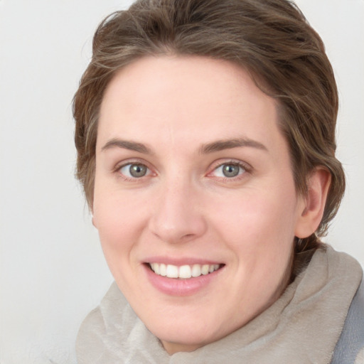 Joyful white young-adult female with medium  brown hair and blue eyes