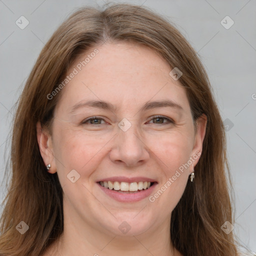 Joyful white adult female with long  brown hair and grey eyes