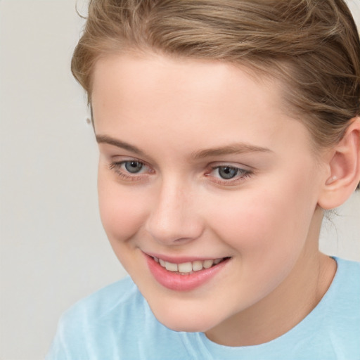 Joyful white child female with short  brown hair and grey eyes