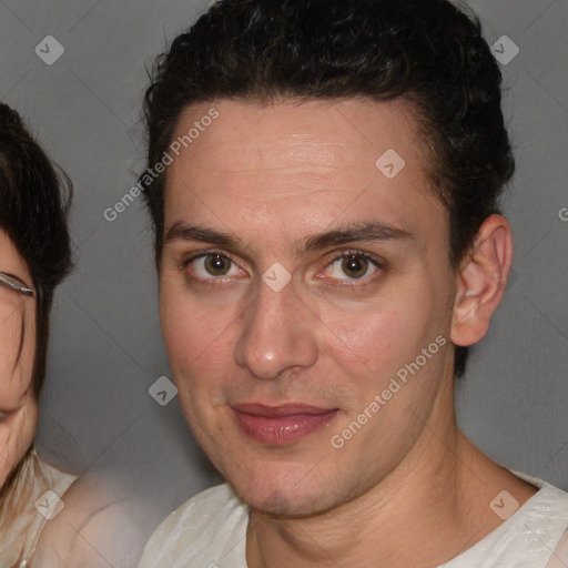 Joyful white adult male with short  brown hair and brown eyes