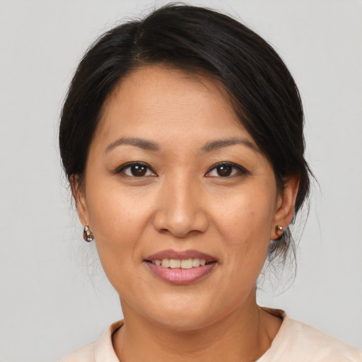 Joyful asian young-adult female with medium  brown hair and brown eyes