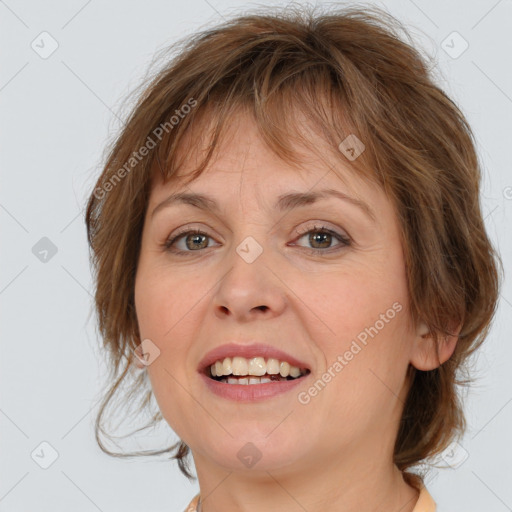 Joyful white young-adult female with medium  brown hair and blue eyes