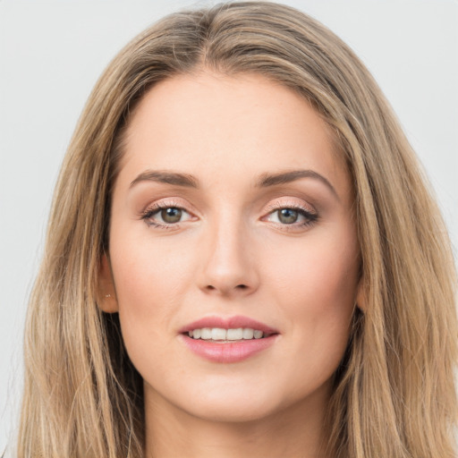 Joyful white young-adult female with long  brown hair and green eyes