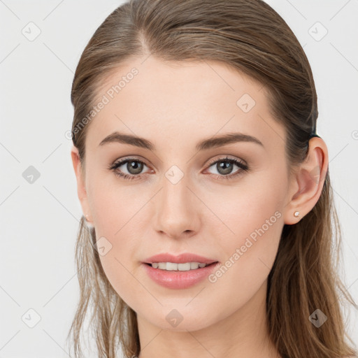 Joyful white young-adult female with long  brown hair and blue eyes