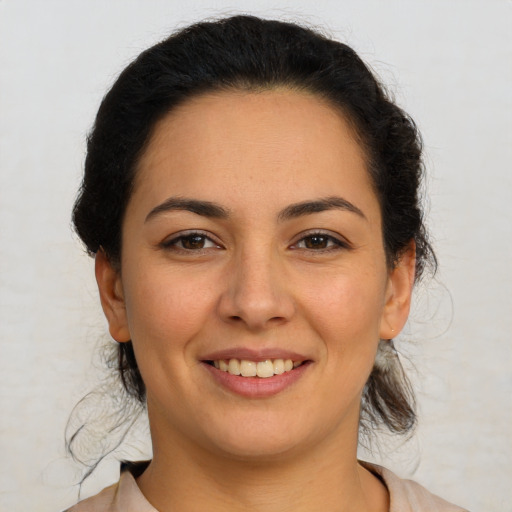 Joyful latino young-adult female with medium  brown hair and brown eyes