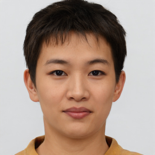 Joyful asian young-adult male with short  brown hair and brown eyes