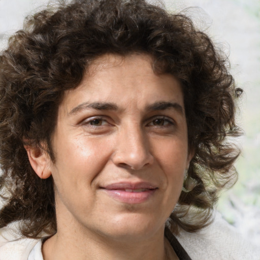 Joyful white adult male with medium  brown hair and brown eyes