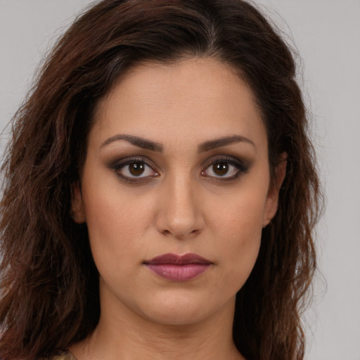 Joyful white young-adult female with long  brown hair and brown eyes