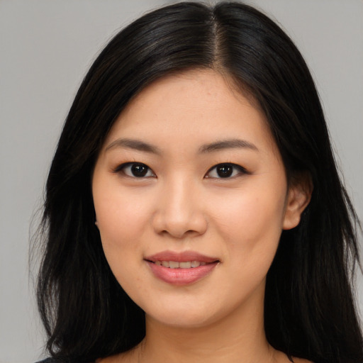 Joyful asian young-adult female with long  black hair and brown eyes