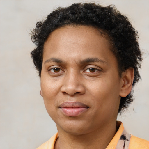 Joyful black young-adult male with short  brown hair and brown eyes