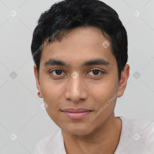 Joyful asian young-adult male with short  black hair and brown eyes