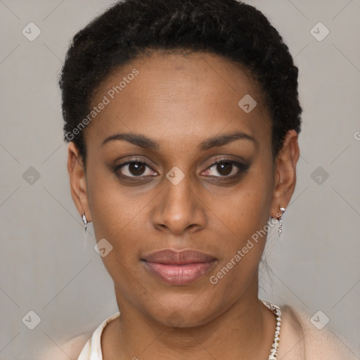 Joyful black young-adult female with short  black hair and brown eyes