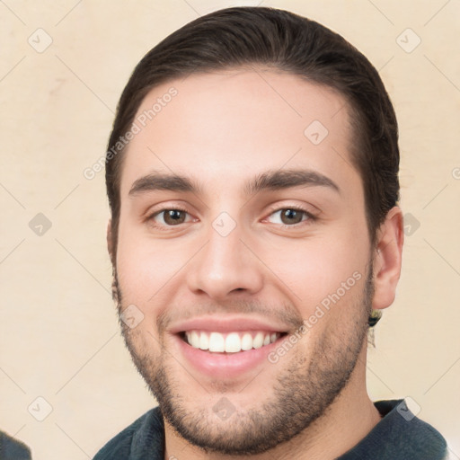 Joyful white young-adult male with short  brown hair and brown eyes