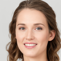 Joyful white young-adult female with long  brown hair and blue eyes