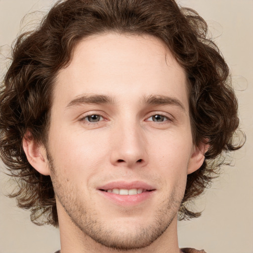 Joyful white young-adult male with medium  brown hair and brown eyes