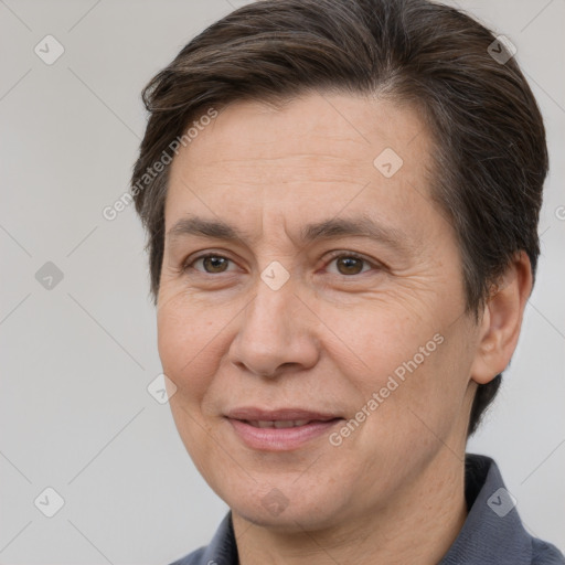 Joyful white adult female with short  brown hair and brown eyes