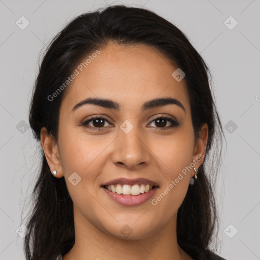 Joyful latino young-adult female with long  brown hair and brown eyes