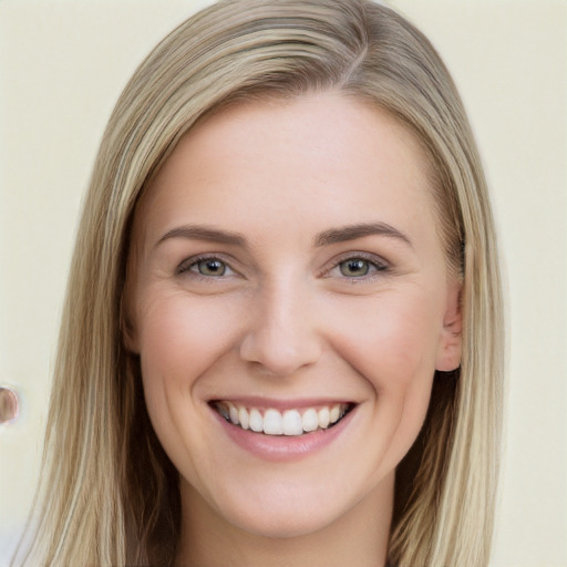 Joyful white young-adult female with long  brown hair and blue eyes