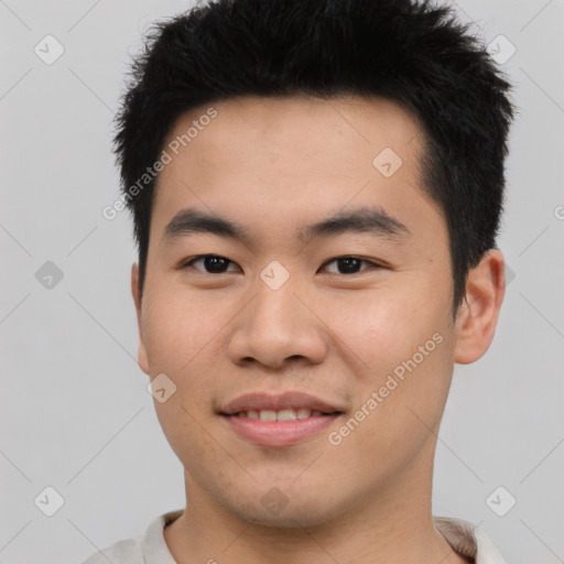 Joyful asian young-adult male with short  black hair and brown eyes