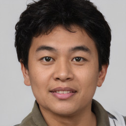 Joyful asian young-adult male with short  brown hair and brown eyes