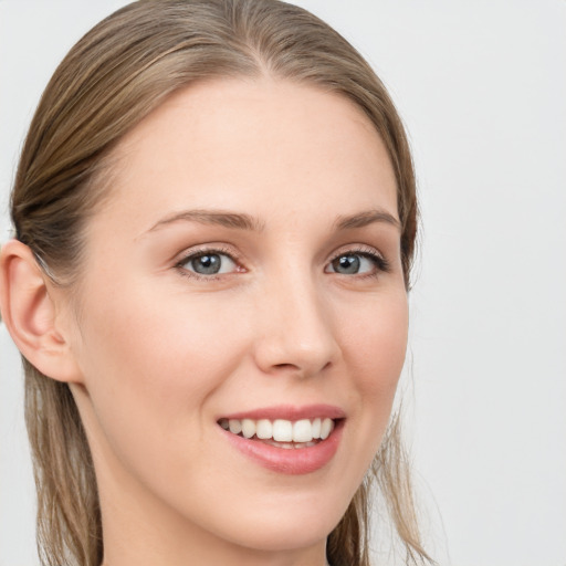 Joyful white young-adult female with long  brown hair and grey eyes