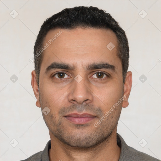 Joyful white young-adult male with short  black hair and brown eyes