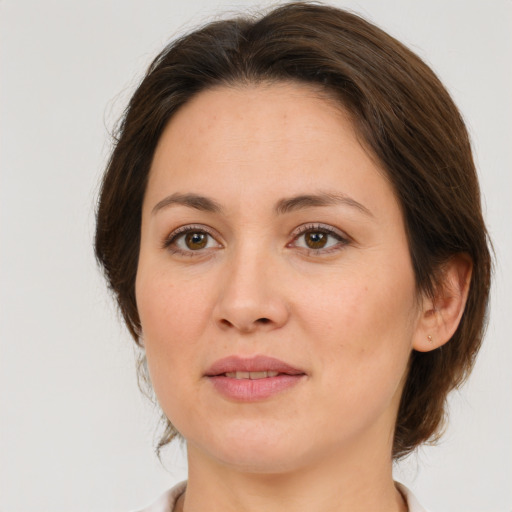 Joyful white adult female with medium  brown hair and brown eyes
