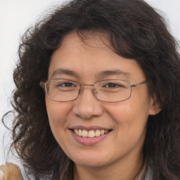 Joyful white adult female with long  brown hair and brown eyes