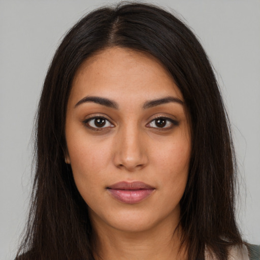 Neutral latino young-adult female with long  brown hair and brown eyes