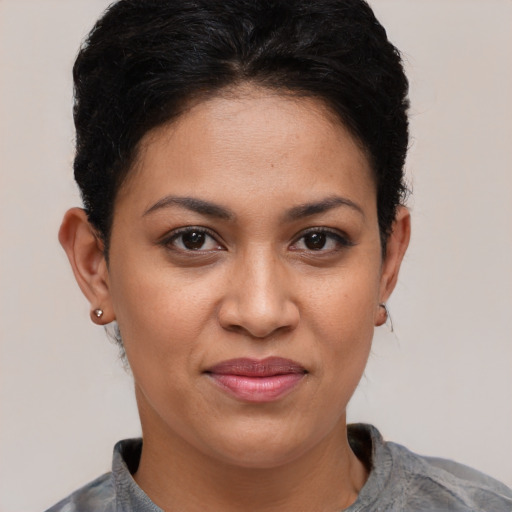 Joyful latino young-adult female with short  brown hair and brown eyes