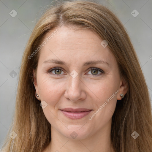 Joyful white adult female with long  brown hair and grey eyes