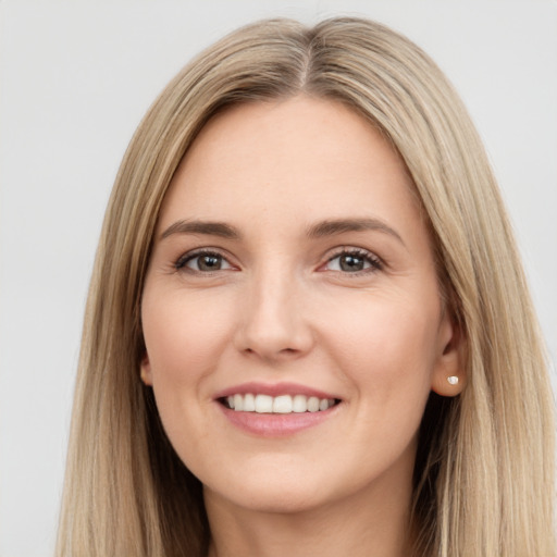 Joyful white young-adult female with long  brown hair and brown eyes