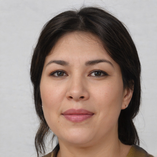 Joyful asian adult female with medium  brown hair and brown eyes