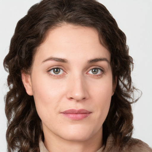 Joyful white young-adult female with medium  brown hair and green eyes