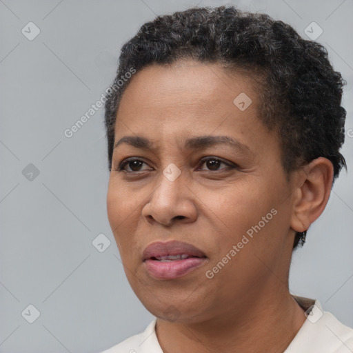 Joyful black adult female with short  black hair and brown eyes